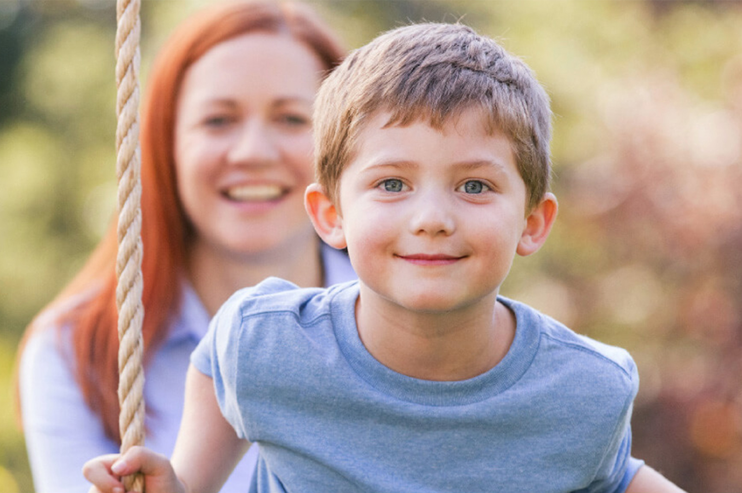 Image of a happy young boy playing with his mother