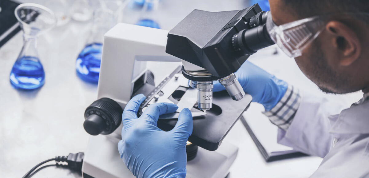 Image of a scientist using a microscope