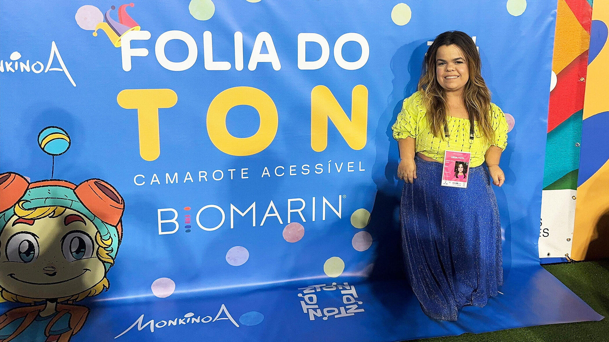 Rebeca Costa standing in front of a banner at Carnival