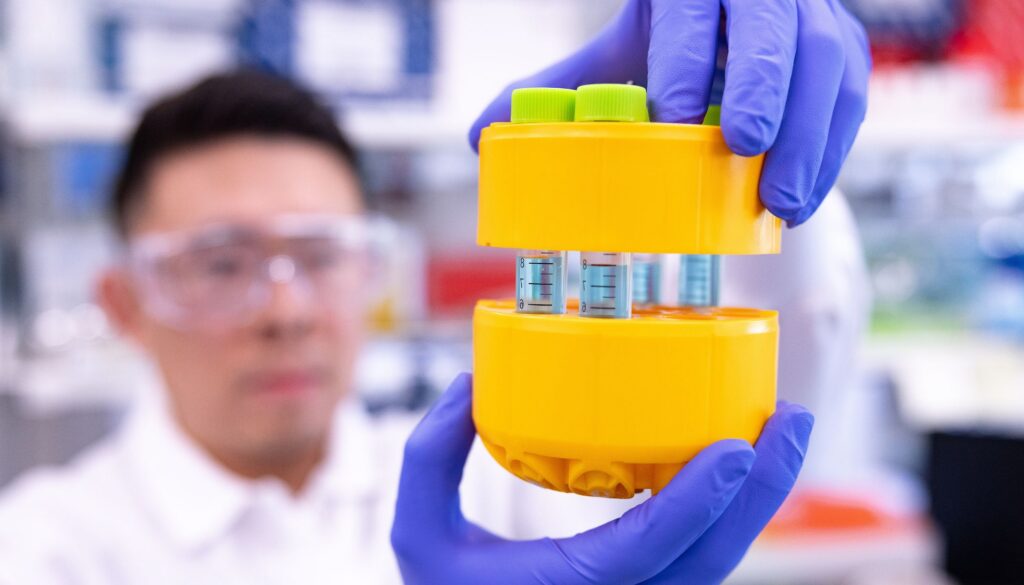 BioMarin scientist holding up vials in a lab